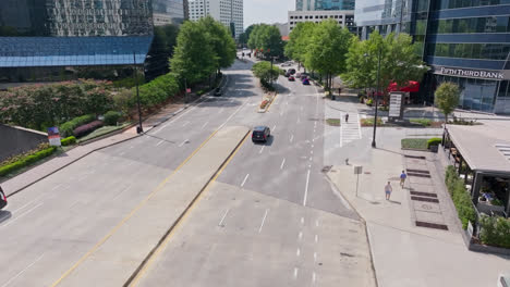 Driving-cars-on-road-along-Fifth-Third-Bank-in-Atlanta-City-at-sun