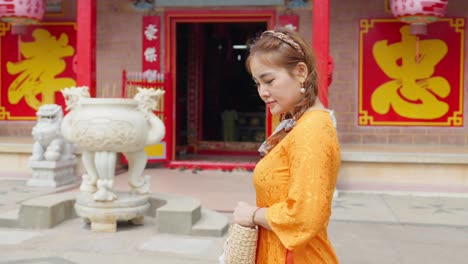 Close-up-of-an-Asian-girl-in-national-costume-walking-to-visit-a-pagoda