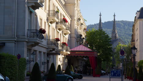 Vehicles-Parked-Near-the-Main-Entrance-of-Brenners-Park-Hotel-and-Spa-in-Baden-Baden,-Germany---Panning-Shot