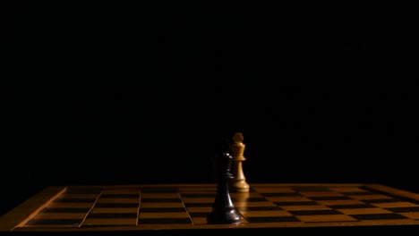 Two-king-chess-pieces-are-facing-each-other-on-opposite-side's-of-the-chessboard