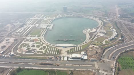 Rajkot-Atal-lake-drone-view-where-many-different-big-lake-and-surrounding-garden-and-road-roads-are-visible,-Rajkot-New-Race-Course,-Atal-Sarovar