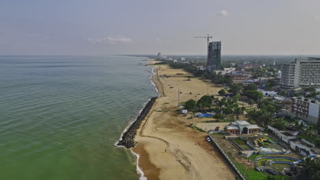 Negombo-Sri-Lanka-Aerial-v7-drone-flyover-above-Browns-beach-capturing-beautiful-calms-water,-beachfront-hotels-and-residential-houses---Shot-with-Mavic-3-Cine---April-2023