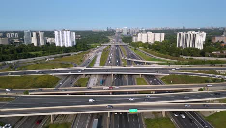 Busy-highway-interchange-with-cars,-trucks,-vans-driving-on-multi-lane-road-network