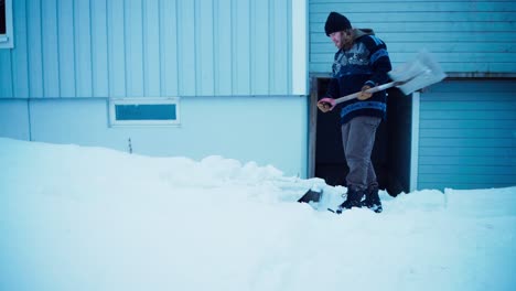 Man-Clearing-Deep-Snow-With-Shovel---Wide-Shot