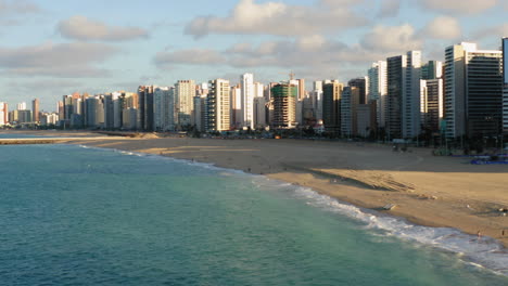 Aerial-view-from-the-ocean-to-the-buildings-in-front-of-the-beach,-Fortaleza,-Ceara,-Brazil