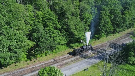 An-Aerial-View-of-an-Antique-Shay-Steam-Locomotive-Backing-Up-to-Approach-a-Station-in-Slow-Motion-on-a-Sunny-Summer-Morning