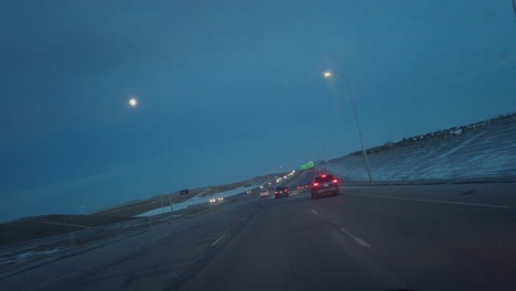 Highway-cars-tilted-view-with-full-moon-at-evening-in-Calgary,-Alberta,-Canada