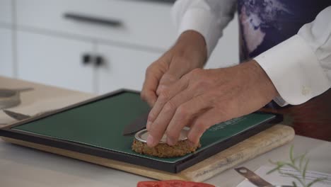 Using-a-bottle-cap-to-shape-blended-vegetables-into-a-raw-vegan-burger-pate