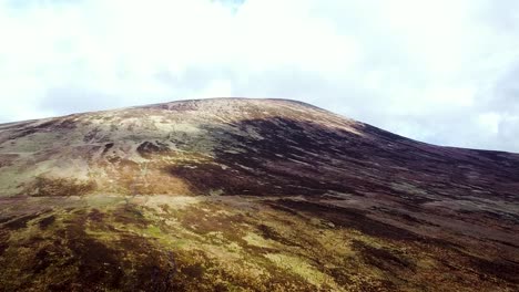 Aerial-drone-shot-of-the-mountainous-topography-and-arid-landscape-at-the-foothills-of-the-Wicklow-Mountains-in-Dublin,-Ireland