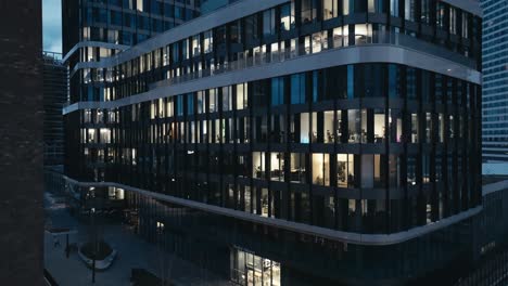 Modern-office-building-at-night---aerial-drone-view