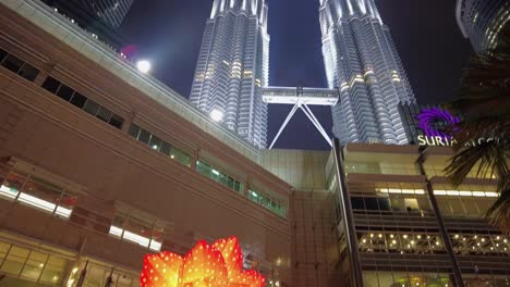 Nighttime-view-of-the-Petronas-Twin-Towers,-an-iconic-symbol-of-Malaysia's-prosperity-and-the-country's-booming-oil-based-economy