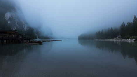 Misty-weather-over-lake-near-Dolomite-mountains,-time-lapse
