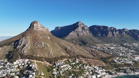 Drone-shot-showing-Lions-Head-Mountain-and-Table-Mountain-that-reveals-Cape-Town,-South-Africa-and-the-Ocean