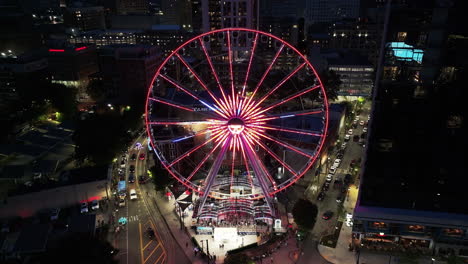 Incredible-light-effects-of-large-Ferris-Wheel-and-buildings-in-urban-borough-in-evening-city