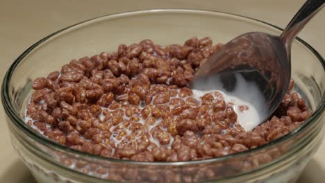 Spooning-some-unhealthy-chocolate-cereals-in-a-bowl-of-milk