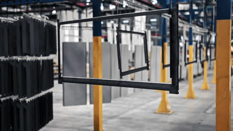 Metal-frame-hanging-on-chains-in-factory