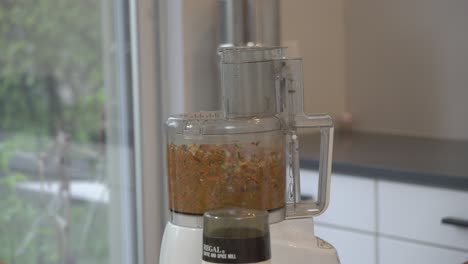 Blending-ingredients-inside-of-food-processor-to-achieve-a-consistency-to-make-a-vegan-burger-pate