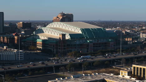 Telephoto-drone-shot-circling-the-Minute-maid-park,-golden-hour-in-Houston,-USA