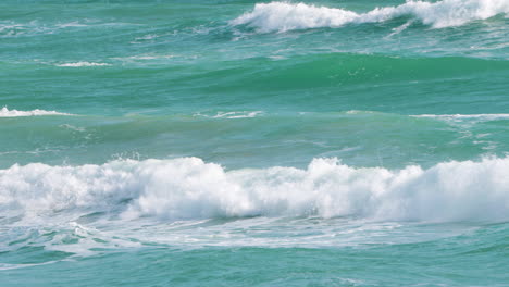 Emerald-Sea-Waves-Forming-and-Breaking-Creating-White-Foam-While-Rolling-on-Sunny-Day-in-Tropics