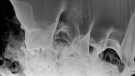 Steady-flow-of-white-smoke-on-dark-background-forms-a-curtain-like-structure-before-dissipating-across-entire-frame