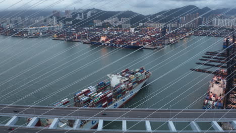 Large-rusty-Cosco-Container-Ship-passing-under-suspension-bridge-arriving-Hong-Kong-port