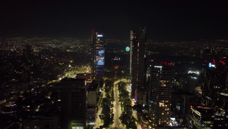 Drone-flying-along-the-Reforma-avenue,-vivid-New-Years-eve-night-in-Mexico-city