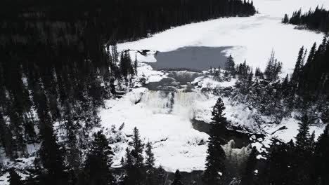 Cinematic-Orbit-4K-Drone-In-Shot-of-environment-nature-Tourism-Travel-Landmark-frozen-winter-Pisew-Kwasitchewan-Falls-Waterfall-Provincial-Park-near-Thompson-Manitoba-Northern-Arctic-Canada-Landscape
