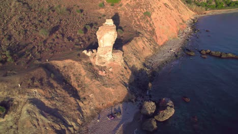 Aerial-orbiting-around-an-abandoned-rocky-tower-ruins-in-Nerja,-Andalusia,-Spain