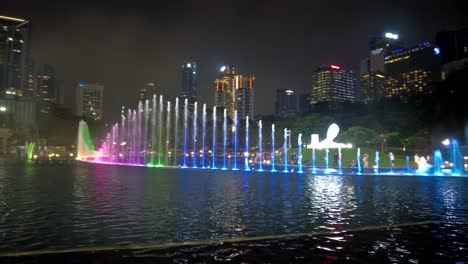Nighttime-view-of-the-water-features-in-front-of-the-Petronas-Twin-Towers,-an-iconic-symbol-of-Malaysia's-prosperity-and-the-country's-booming-oil-based-economy