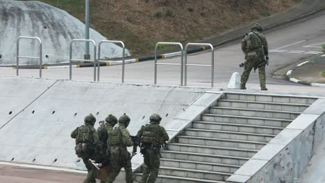 Police-officers-perform-a-staged-counter-terrorism-drill-as-they-carry-an-injured-attack,-or-terrorist,-during-an-open-day-to-celebrate-National-Security-Education-Day-in-Hong-Kong,-China