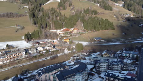 Eine-Luftaufnahme-Von-Innichen-Und-Dem-Luxuriösen-Naturhotel-Leitlhof-Innichen,-Einem-Charmanten-Hotel-Im-Alpinen-Stil,-Umgeben-Von-Einer-Winterlichen-Waldlandschaft
