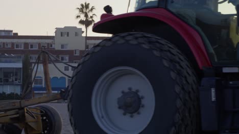 Massey-Ferguson-tractor-driving-in-Venice-Beach,-California-in-slow-motion