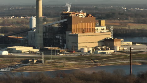 Telephoto-aerial-shot-reveal-of-Flint-Creek-Power-Plant-by-lake-Swepco,-tilt-up