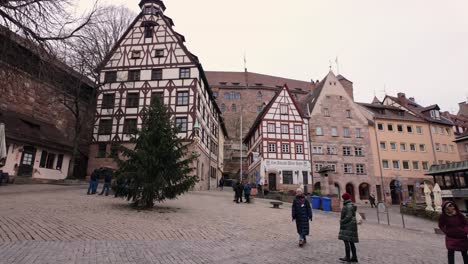 Tourists-visiting-the-various-historical-landmarks-near-the-imperial-castle-in-Nuremberg,-Germany