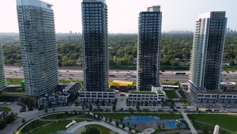 Housing-development-construction-crane-with-townhouses-and-high-rise-condo-towers-near-highway
