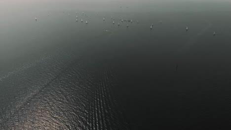 A-wide-tilt-up-shot-of-a-sailboat-race-in-central-Europe