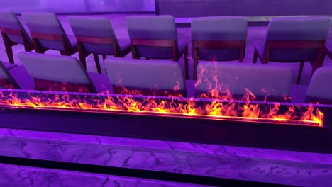 Static-view-of-a-modern-fireplace-with-flames-inside-a-convention-hall