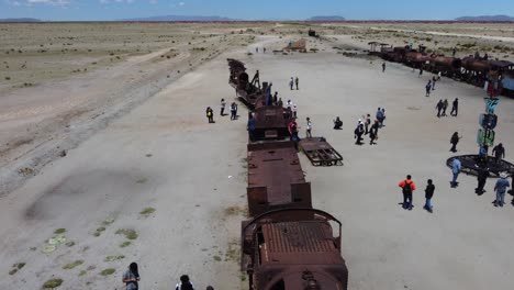 Flyover:-Tourists-at-abandoned-train-graveyard-near-Uyuni-in-Bolivia