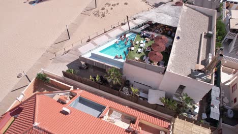 Aerial-View-of-Pool-Party-on-La-Mata-Beach,-Spain