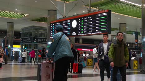 Passagiere-Mit-Gepäck-Greifen-In-Der-Ankunfts--Und-Abflughalle-Des-Hochgeschwindigkeitsbahnhofs-Von-Taoyuan-Auf-Flughafen-Verbindungsnetze-Zu,-Tourismus-In-Taiwan,-Handgeführte-Bewegungsaufnahme
