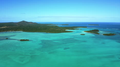 Isle-of-Pines-New-Caledonia-crystal-clear-waters-and-N'Ga-Peak---stunning-aerial-flyover