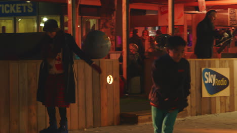 Woman-steps-with-skates-on-ice-at-night-and-starts-skating