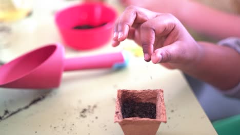 Young-children-learning-how-to-plant-seeds-in-garden