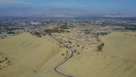 City-of-Ica-near-Huacachina-Oasis-with-Road-Leading-to-the-City-Between-Sand-Dunes-in-Peru,-South-America