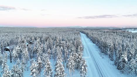 Road-Through-Snowy-Pine-Tree-Forest-During-Winter-In-Finland