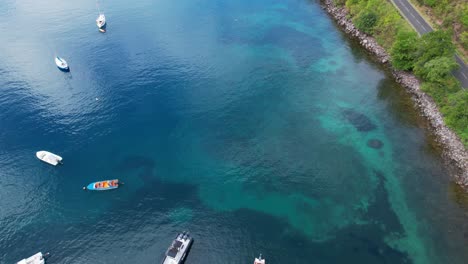Boats-On-The-Tranquil-Bay-Of-Anse-A-La-Barque-In-Vieux-Habitants,-Guadeloupe,-France---Aerial-Drone-Shot