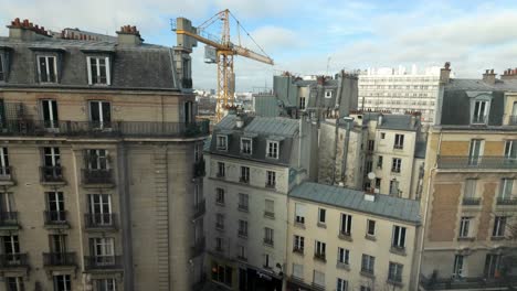 Paris-construction-crane,-rooftops-and-buildings-4K-24FPS
