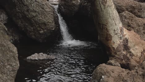 Still-footage-of-a-small-waterfall-into-a-river