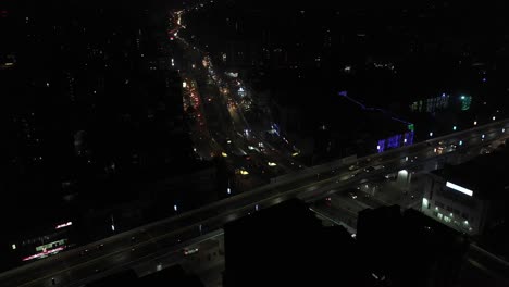Rajkot-Aerial-Drone-View-You-see-all-the-vehicles-going-over-the-bridge-and-many-vehicles-going-under-where-big-buildings-are-visible-all-around