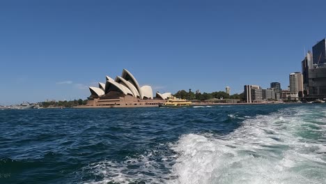 Water-taxi-passing-Opera-House,-passengers-treated-to-unparalleled-view